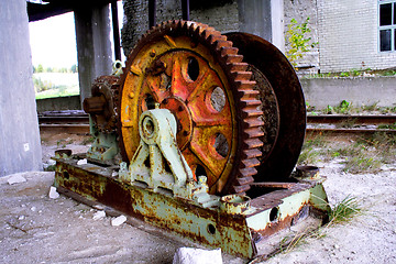 Image showing Rusty mine shaft mechanism on dusty ground