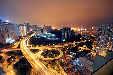 Image showing Freeway in night with cars light in modern city. 