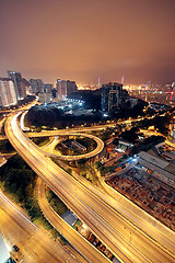 Image showing Freeway in night with cars light in modern city. 