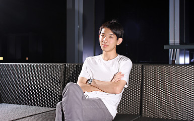 Image showing Man sit on a bench while relaxing at a pub. 