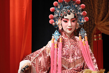 Image showing chinese opera dummy and red cloth as text space ,it is a toy,not