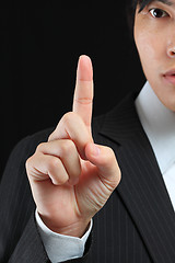 Image showing young business man in a suit pointing with his finger