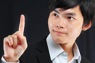 Image showing young business man in a suit pointing with his finger