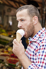 Image showing man eats icecream