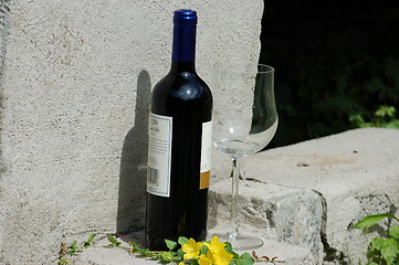 Image showing Red wine and glass on concrete