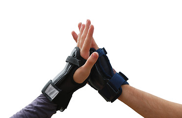 Image showing Teen arms in roller wrist guards salutation isolated