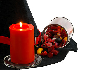 Image showing Halloween candies and candle isolated