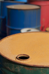 Image showing Old colored barrels for oil products