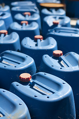 Image showing Old blue canisters for oil products