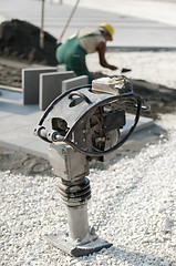 Image showing A worker puts exterior tiles 