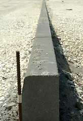 Image showing Curb and gravel on the road in repair. Placed 