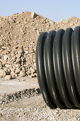 Image showing Pipes and piles of sand in the background