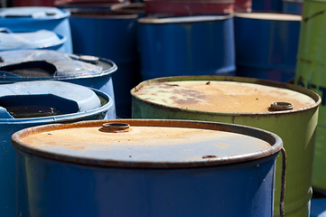 Image showing Old colored barrels for oil products