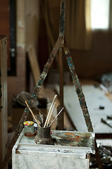Image showing Easel and paint brushes