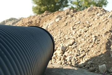 Image showing Pipes and piles of sand in the background