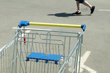 Image showing Shopping cart and a man who walks