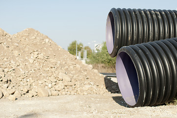 Image showing Pipes and piles of sand in the background