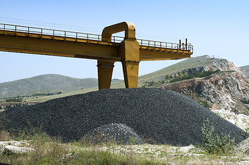 Image showing Asphalt pile and crane in quarry