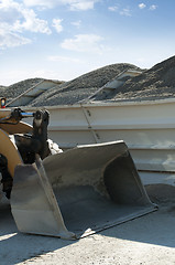 Image showing Excavator close-up and piles of sand 