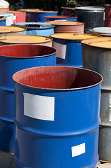 Image showing Old colored barrels for oil products