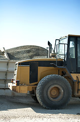 Image showing Excavator close-up and piles of sand 