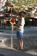 Image showing Children pour sand