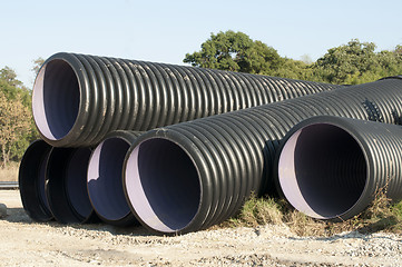 Image showing Pipes and piles of sand in the background