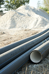 Image showing Pipes and piles of sand in the background