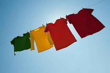 Image showing Sunshine behind colorful clothes on a laundry line