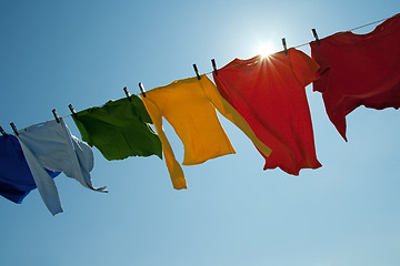 Image showing Sun shining over a laundry line with bright clothes