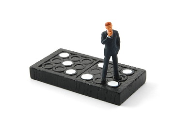 Image showing business man on domino isolated