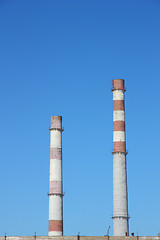 Image showing chimneys  large plant against the blue sky