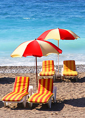 Image showing Beach chairs and umbrellas on a sand beach
