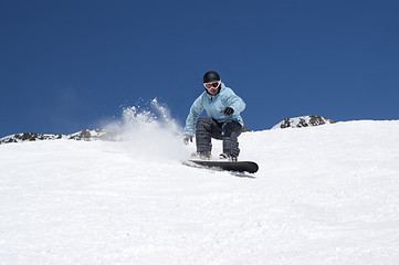 Image showing Snowboarding in snowy mountains