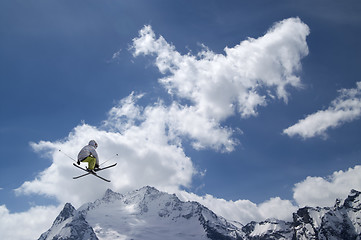 Image showing Freestyle ski jumper with crossed skis