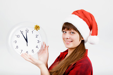 Image showing attractive girl with a clock