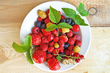 Image showing Berries on a plate on a wooden board