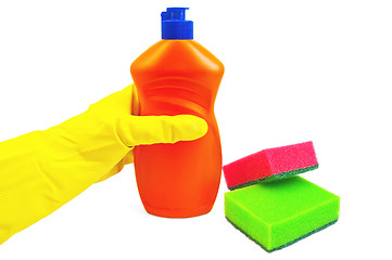 Image showing Bottle of orange with a yellow-gloved hand and sponges