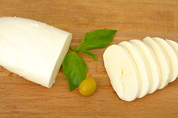 Image showing mozzarella cheese on a wooden background