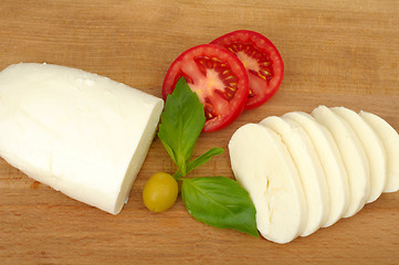 Image showing mozzarella cheese on a wooden background