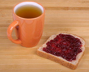 Image showing cup of tea and a sandwich with jam