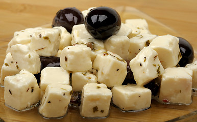 Image showing cheese and olives in oil on a plate