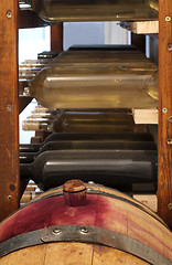 Image showing A little wine barrel and bottles wine