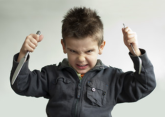 Image showing Child with a knife and fork