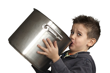 Image showing Child drinking milk from a big saucepan