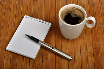 Image showing notebook with a pen and a cup of coffee