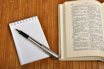 Image showing notebook with pen and old Russian-German dictionary