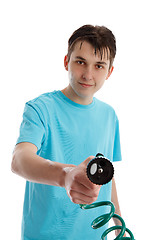 Image showing Smiling boy holding garden hose