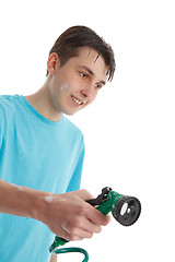 Image showing Boy using a garden hose