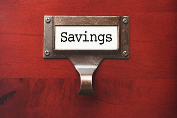 Image showing Lustrous Wooden Cabinet with Savings File Label